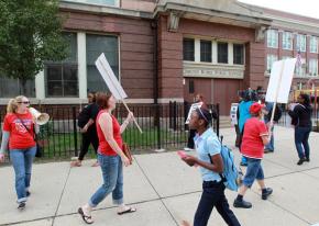 Teachers join in an informational picket outside an elementary school