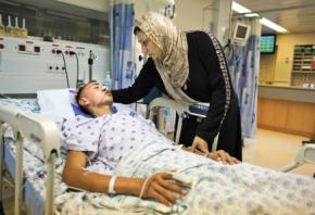 Jamal Julani lies in a hospital bed after being beaten and left for dead