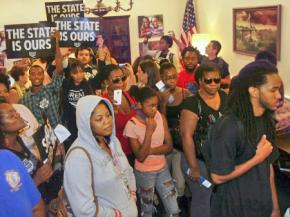 Dream Defenders flood into the hallway outside Gov. Rick Scott's office in the Florida state Capitol