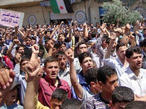 Protesters against the Assad regime march in Homs
