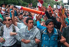 Striking teachers march past Mexico's presidential residence