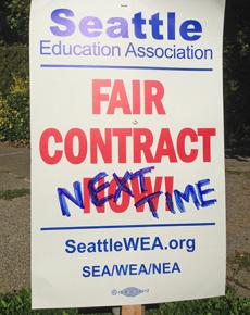 A union picket sign amended after ratification of the contract