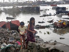 Residents sift through the wreckage of their homes in Tacloban