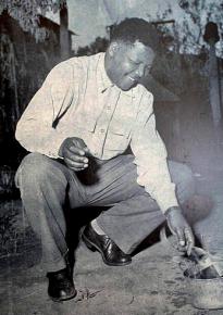 Nelson Mandela burning an identification pass in 1960