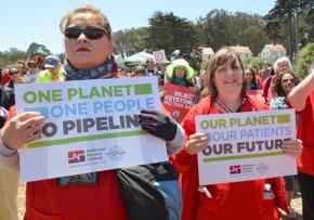 Nurses protest the Keystone XL pipeline project as a threat to the health of people and the planet