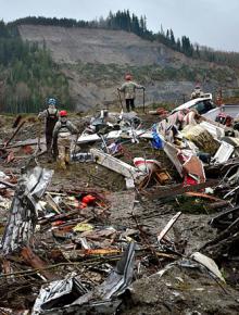 Rescuers search through debris in the aftermath of the deadly mudslide near Oso, Wash.