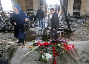People mourn victims inside the burned-out trade union building in Odessa