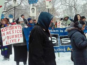 Protesters endure the winter weather outside the White House during Enrique Peña Nieto's visit