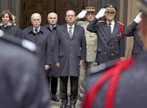 François Hollande stands for a moment of silence at police headquarters in Paris