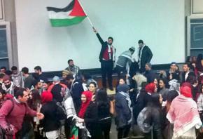 Students celebrate after the UC Davis student government passes a divestment resolution