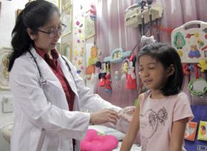A doctor administers a vaccine