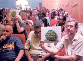 Opponents of the plan to sell the Brooklyn Heights Library protest at a meeting of Brooklyn Community Board 2