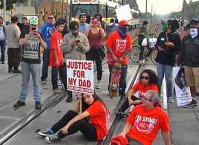 Protesters in Long Beach block a commuter train to demand justice