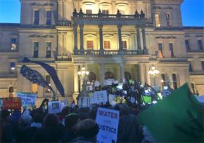 Hundreds demonstrated outside the Michigan state Capitol building as the governor was speaking