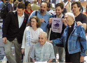 Father Daniel Berrigan (seated) joins a solidarity demonstration for Occupy activists facing charges for civil disobedience