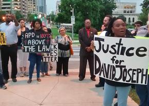 Opponents of police violence gather to protest the non-indictment of David Joseph's killer