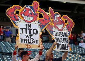 Cleveland Indians fans hold up cut-outs of the team mascot Chief Wahoo