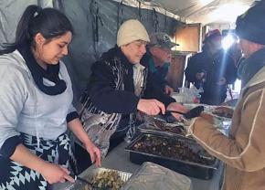 Volunteer chefs serve water protectors in the Oceti Sakowin camp at Standing Rock
