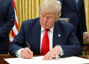 Trump signs an executive order on his first day in the Oval Office