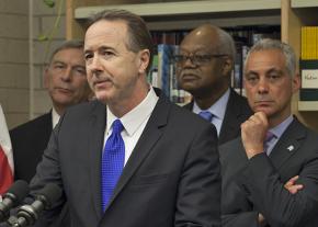Chicago Public Schools CEO Forrest Claypool at the microphone, flanked by Mayor Rahm Emanuel and other officials