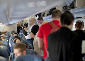 Passengers cram into a Delta Airlines flight