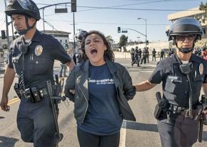 Immigrant rights activist Claudia Rueda is arrested during protests in Los Angeles