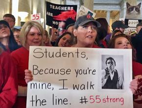 Striking teachers march through the West Virginia State Capitol building