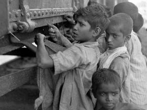 Children attempt to open a grain car in the famine in Bengal during 1943