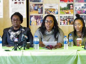 Marcus Deon Smith's mother Mary Smith (left) and sister Kim Suber (center) address reporters