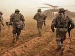 U.S. soldiers run toward Black Hawk helicopters after a search for weapons caches in Iraq (Spc. Luke Thornberry)