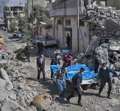 Residents pull victims from the rubble following a coalition air strike in Mosul Residents pull victims from the rubble following a coalition air strike in Mosul