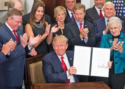 Donald Trump signs an executive order on health care (Andrea Hanks | WhiteHouse.gov)