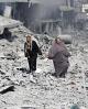 People walk through the rubble during a pause in the Israeli assault on Gaza (Iyad al Baba) People walk through the rubble during a pause in the Israeli assault on Gaza (Iyad al Baba)