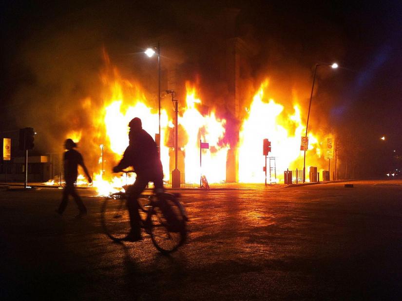 A store blazing on Tottenham High Road on the first night of rioting in London