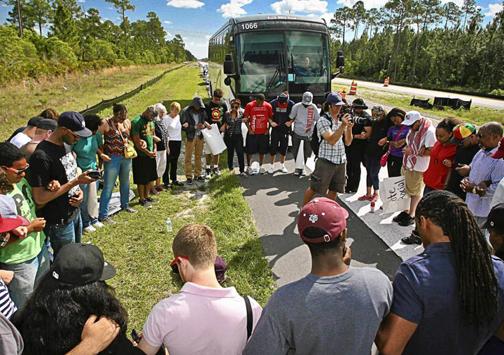 Demonstrators on the march from Daytona Beach to Sanford pause by the side of the highway