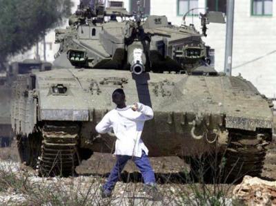 Faris Odeh throws a stone at an Israeli tank ten days before he was gunned down in Gaza