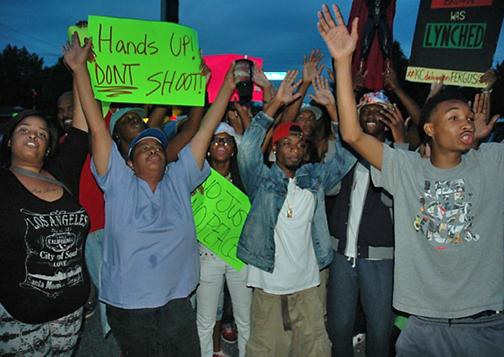 Residents gather in Ferguson, Mo., for an evening protest against police violence
