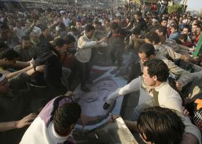 Protesters walk over a picture of Egyptian President Hosni Mubarak during a demonstration in Mahalla al-Kobra in April 2008