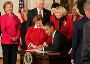 Barack Obama signs legislation on pay discrimination, with Lilly Ledbetter at his side