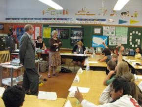 Oregon Gov. Ted Kulongoski visits public school students, who are among those being asked to pay for the crisis