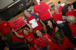 Los Angeles teachers sit in at a school board meeting to protest planned layoffs