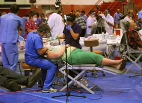 Volunteer dentists and health care workers provide care at the Great Western Forum in Los Angeles