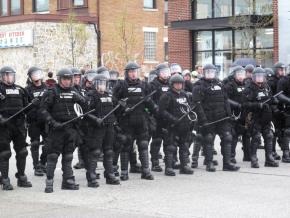 A line of riot police brandish batons at G20 protesters in Pittsburgh