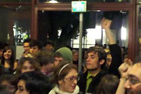 UC Santa Cruz students push through the library entrance chanting "Whose university? Our university!"
