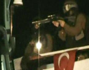 Israeli soldiers fire on solidarity activists after landing on the deck of the lead ship in the Gaza Freedom Flotilla