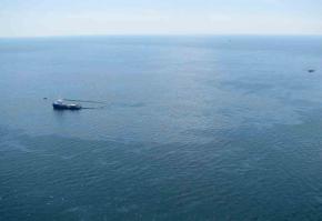 Ships attempt to clean up spilled oil from the Gulf of Mexico where a BP drilling platform exploded and sank