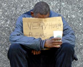 A homeless man asks for help on Chicago's Michigan Avenue
