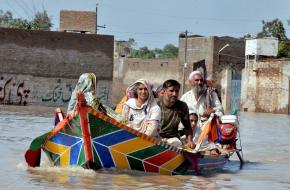A family escaping floods in Northwest Pakistan in July