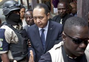 Haitian police lead Jean-Claude "Baby Doc" Duvalier out of his hotel