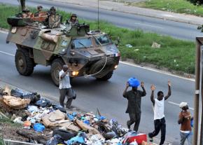 French troops roll through Abidjan in a tank